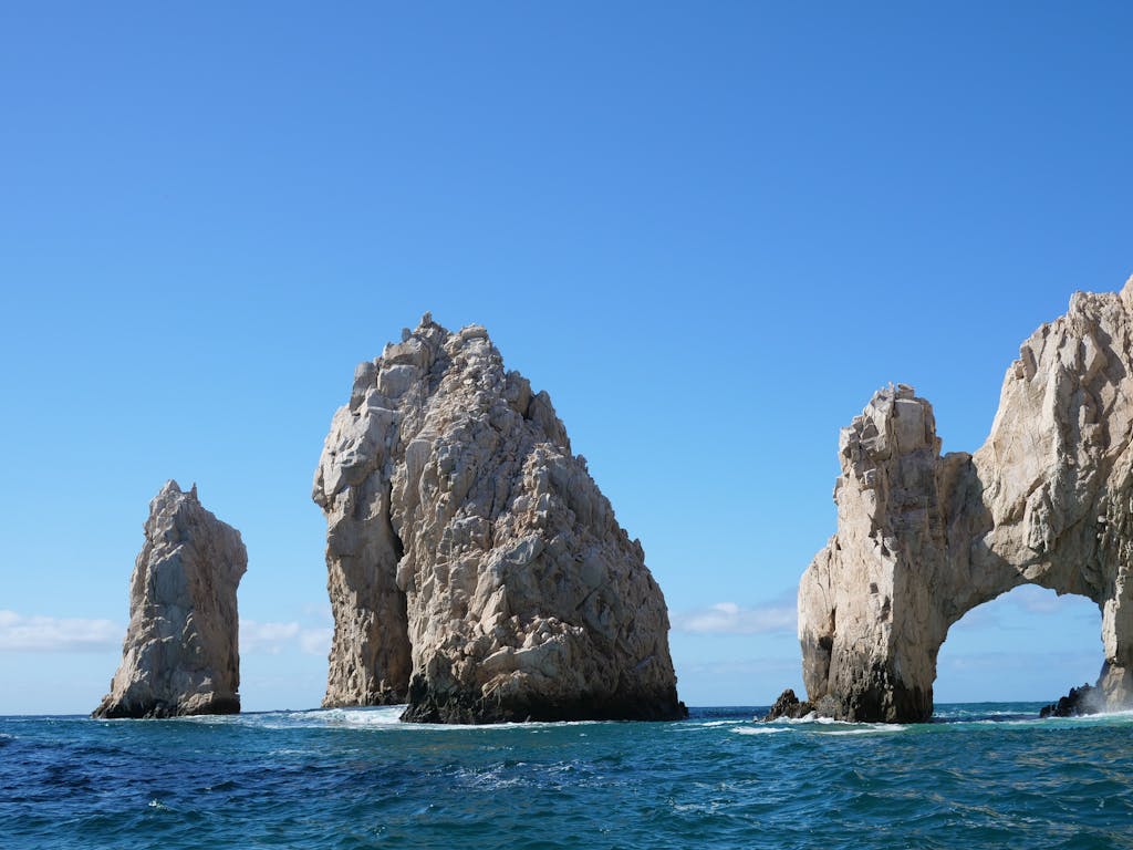 A breathtaking capture of El Arco rock formations in Cabo San Lucas against a clear sky.