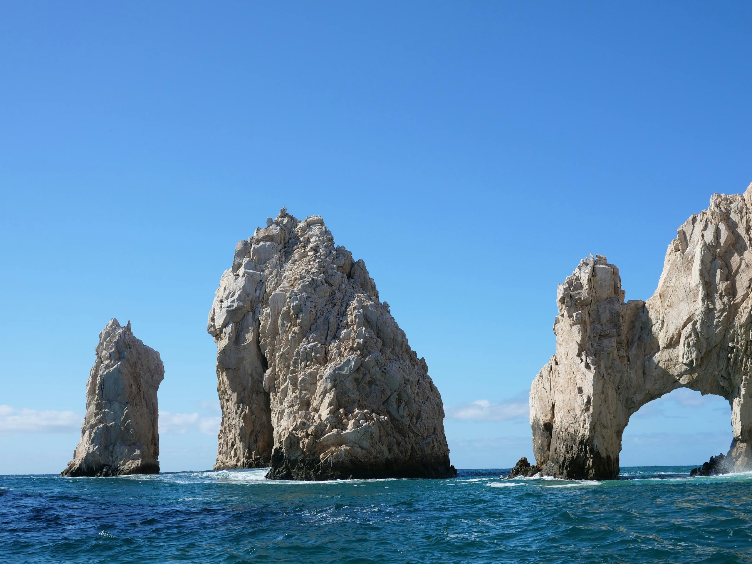 A breathtaking capture of El Arco rock formations in Cabo San Lucas against a clear sky.