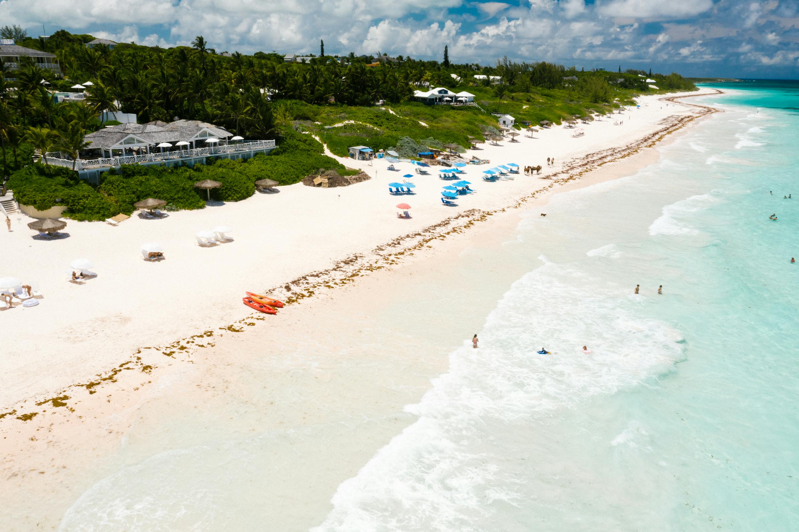 Stunning aerial shot of a tropical beach with clear water and white sand, offering a perfect getaway scene.