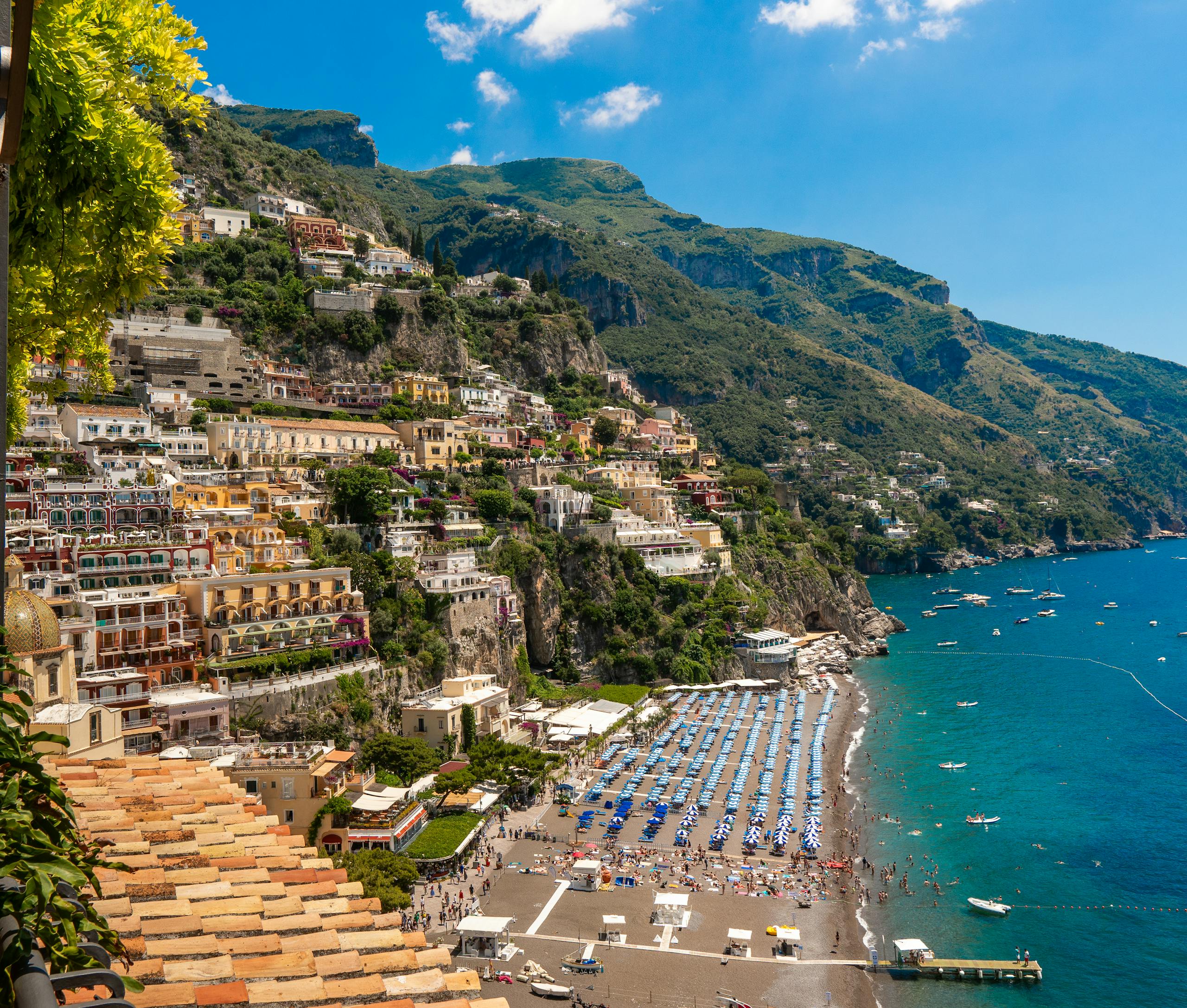 Stunning coastal view of Positano with colorful buildings and serene beach on the Amalfi Coast, Italy.