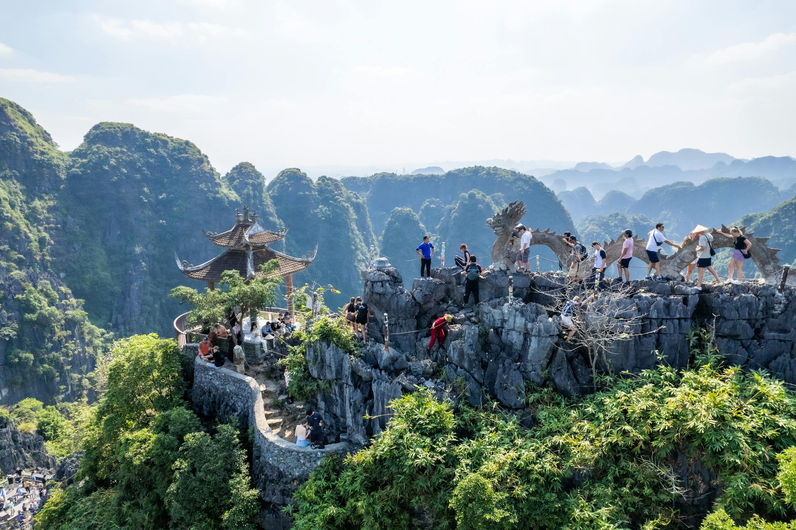 Tourists exploring the stunning landscapes of Mua Caves, Ninh Bình, Vietnam.