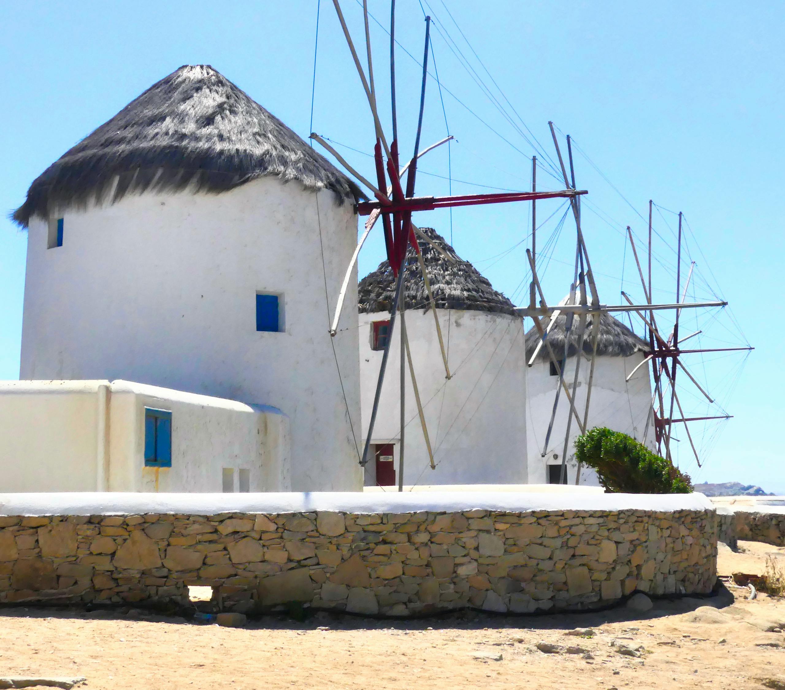 Traditional windmills on Mykonos Island in Greece, showcasing Cycladic architecture.
