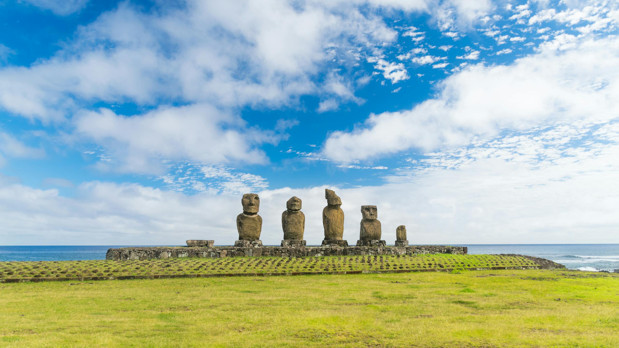 Explore the iconic Moai statues at Tahai Ceremonial Complex on Easter Island with the Pacific Ocean backdrop.