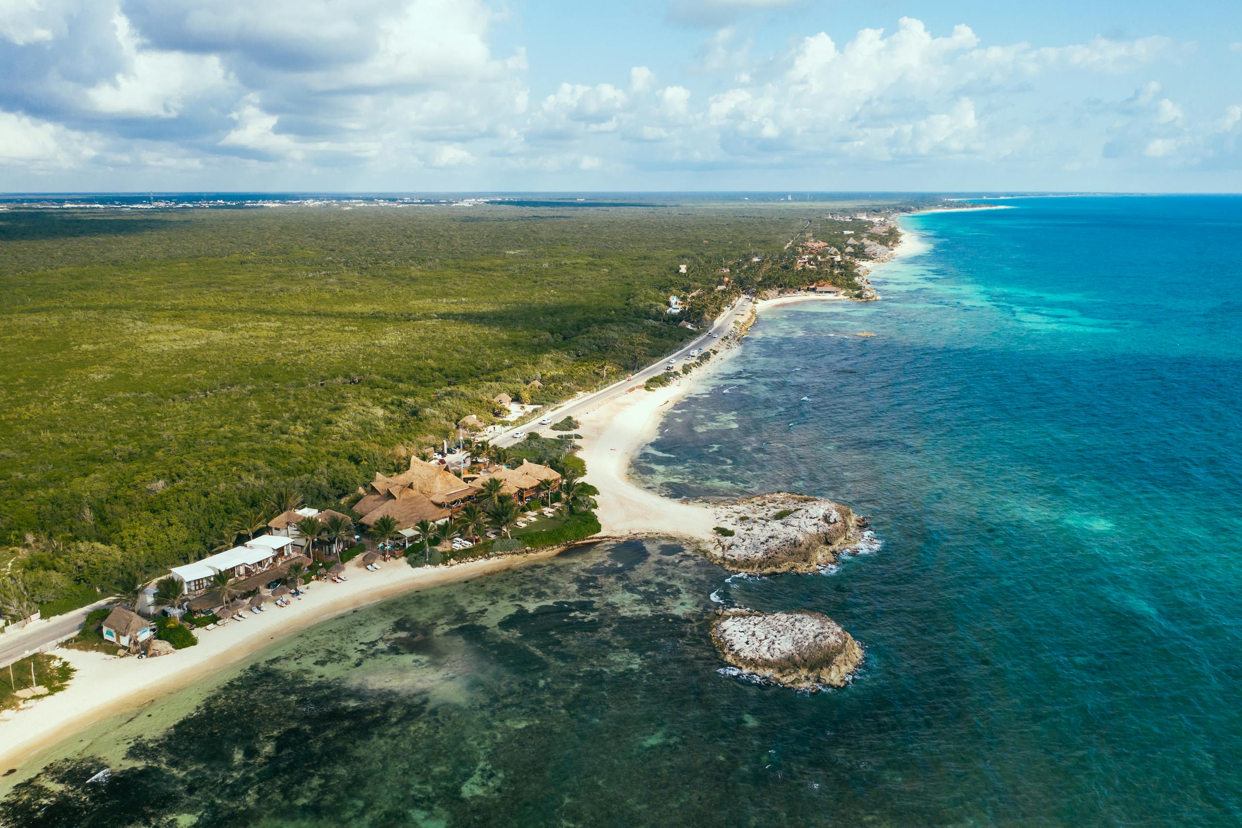Stunning aerial view of the pristine coastline and lush greenery in the Riviera Maya, Mexico.
