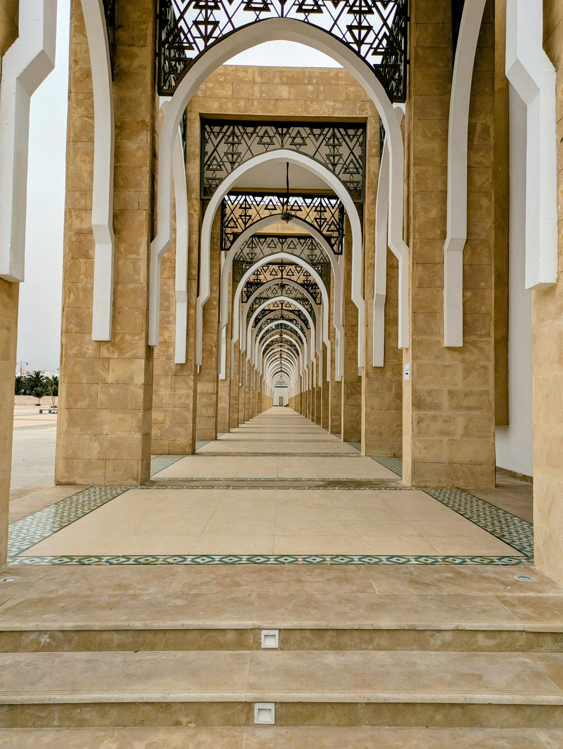 Stunning corridor of arches in Middle Eastern architecture, showcasing intricate and precise design.