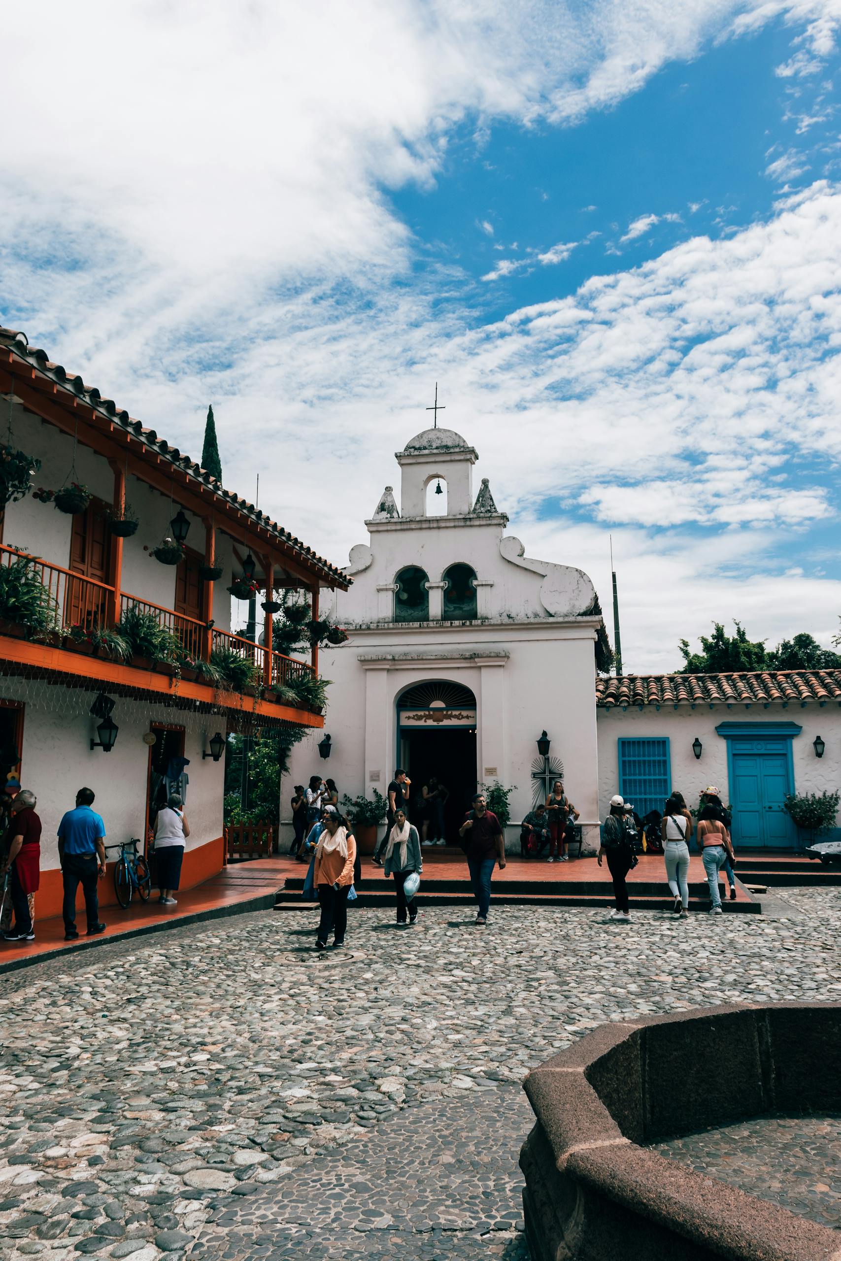 Visitors exploring the vibrant historic Pueblito Paisa in Medellín, Colombia.